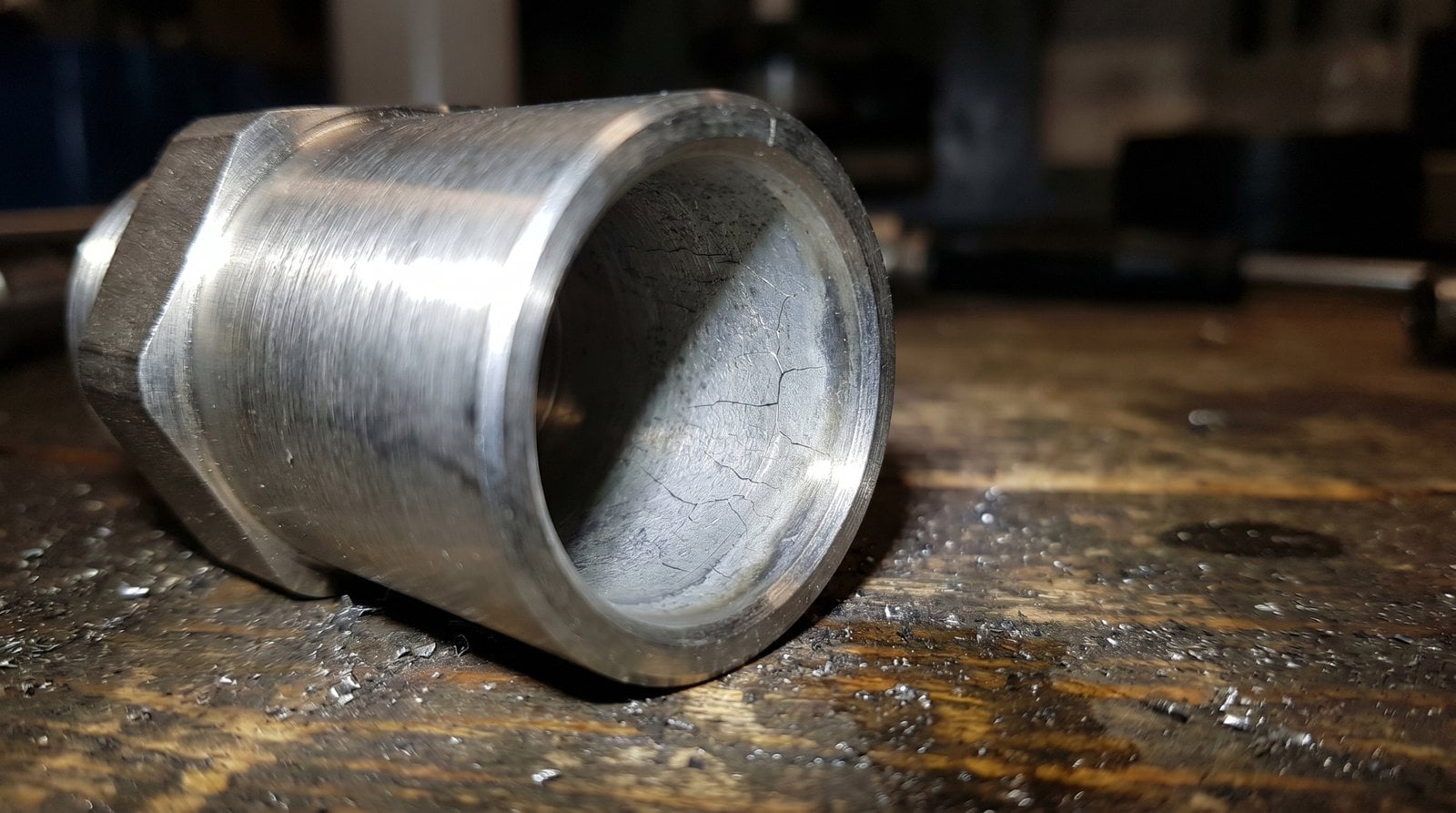 Macro view of hydrogen embrittlement cracking on a sour-service stainless steel tube fitting.