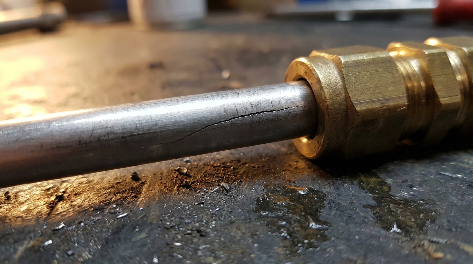 Macro view of fatigue cracking on a tube just upstream of the fitting body due to vibration.